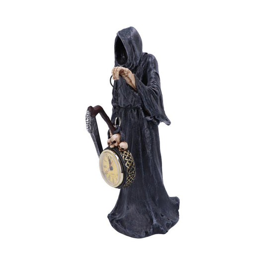 A Grim Reaper figurine holds a scythe and a pocket watch adorned with skulls; it stands against a white background.