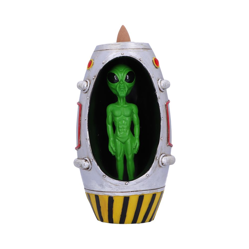 A green alien figurine stands inside a silver, capsule-shaped incense burner with yellow and black stripes at the base, against a white background.