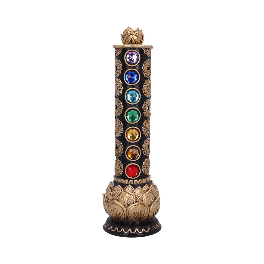 A black incense burner, adorned with gold detailing and seven chakra colored gems, stands upright against a white background.