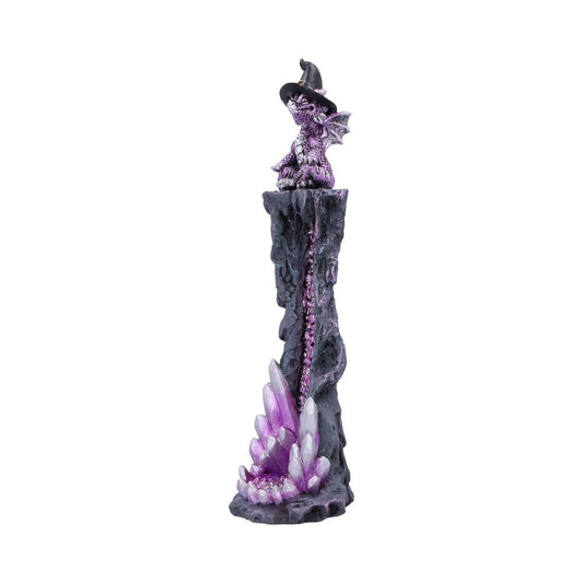 A purple dragon figurine, wearing a witch's hat, sits atop a dark, crystalline rock formation incense burner.