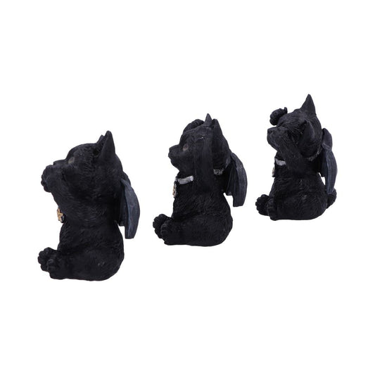 Three black bat-winged cat figurines sit in a row, each posing with paws covering their eyes, ears, and mouth, embodying "see no evil, hear no evil, speak no evil." White background.