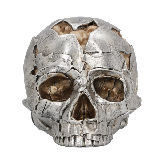 A metallic skull ornament with visible cracks reveals a cream-colored substance resembling a brain, set against a plain white background.