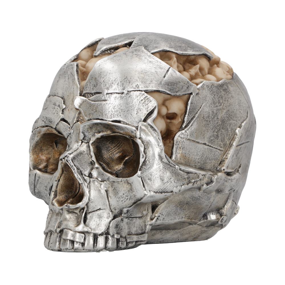 A silver metallic skull sculpture fractures to reveal beige brain-like material inside, set against a plain white background.