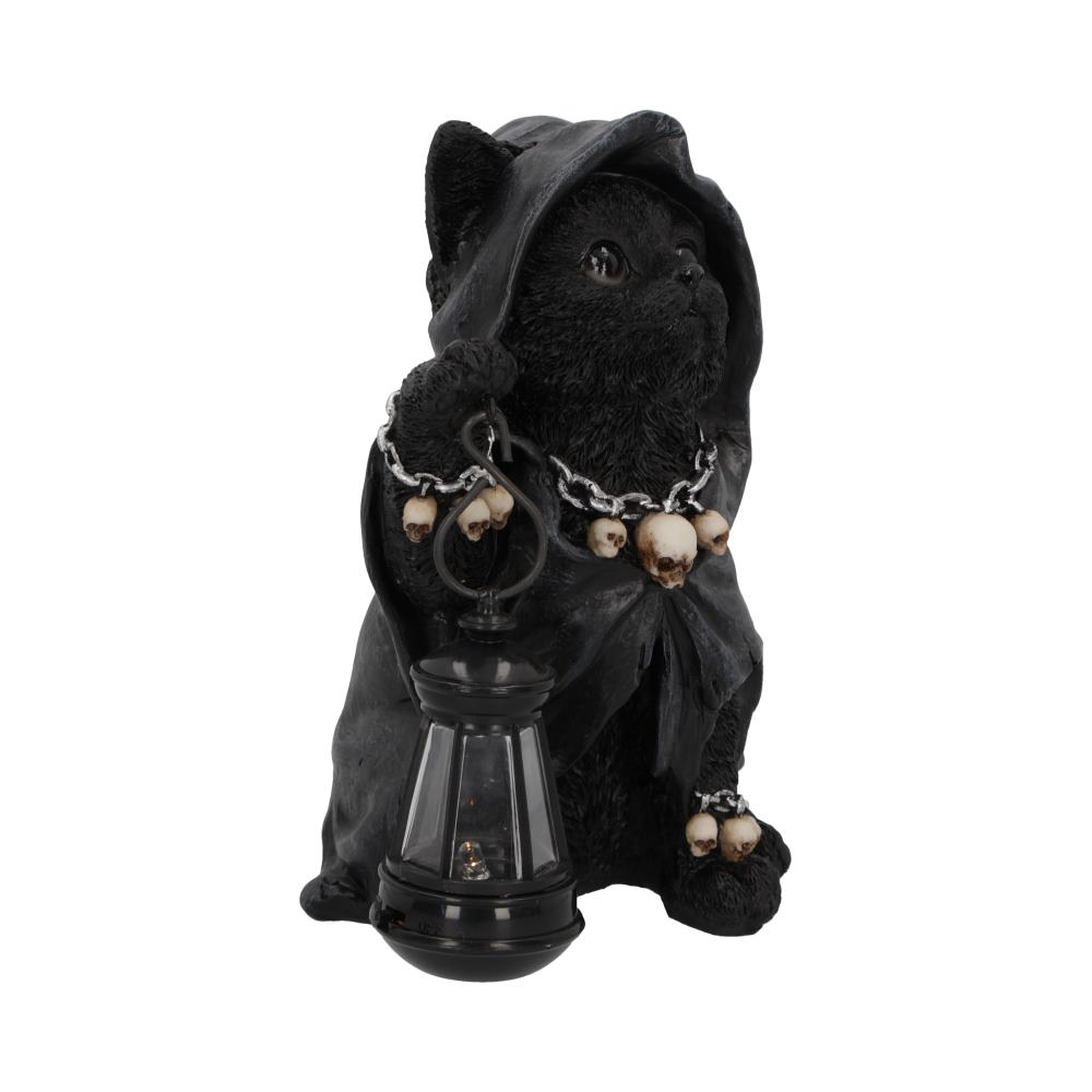 A black cat figurine in a hooded cloak holds a lantern, adorned with skulls on a chain, against a plain white background.