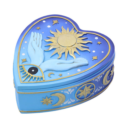 A heart-shaped box features celestial designs: a golden sun, blue hand with an eye, stars, and moons. It is painted in shades of blue with gold accents.