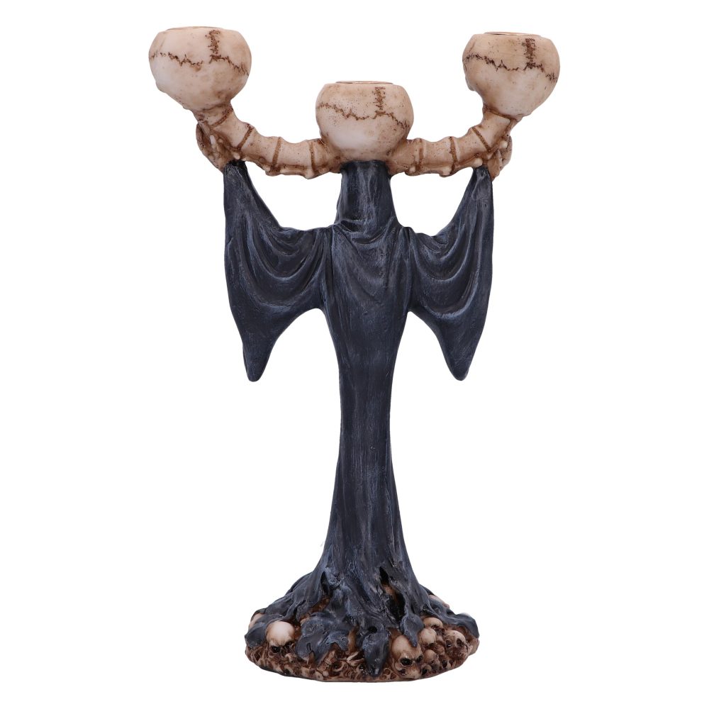 A dark-robed, skeletal candelabra holds up three skull-shaped candle holders with bony arms. The base is littered with small skulls against a white background.