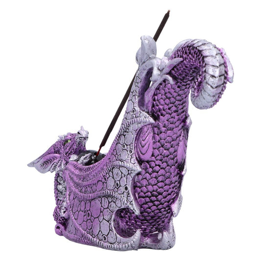 A purple and silver dragon-shaped incense burner holds a burning incense stick.  The burner is sculpted with detailed scales and wing-like features.  It is isolated on a white background.