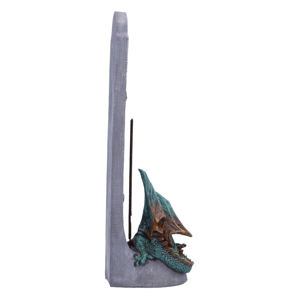 A dragon-shaped incense burner rests against a grey stone-like stand; incense burns within.