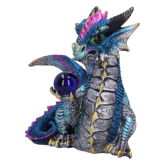 A small, vibrant dragon figurine holds a purple crystal ball with its claw. It features intricate blue, silver, and pink scales and spines, surrounded by a plain white background.