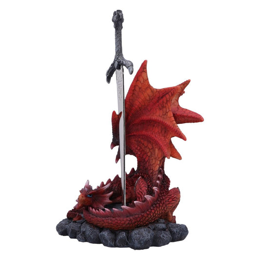 A silver sword is embedded in a red dragon figurine; the dragon is lying down on a rocky base.