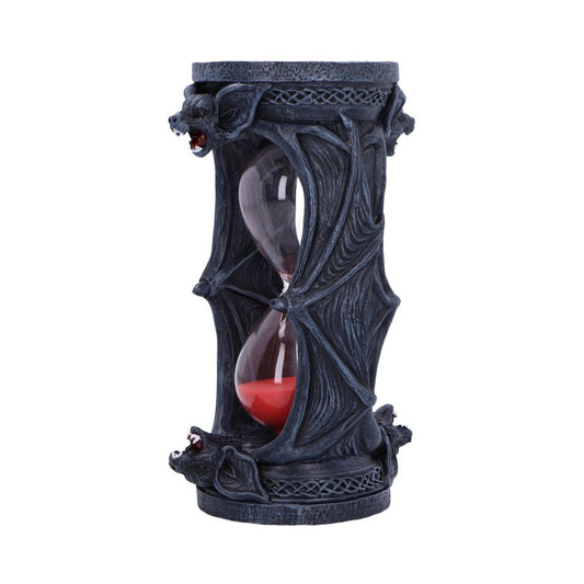 An hourglass with red sand flows through a central glass chamber, surrounded by ornate gothic stone-like structures featuring bat motifs, set against a plain white background.