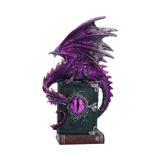 A purple dragon figurine perches atop a dark book-shaped box adorned with a circular emblem resembling an eye, set against a plain white background.