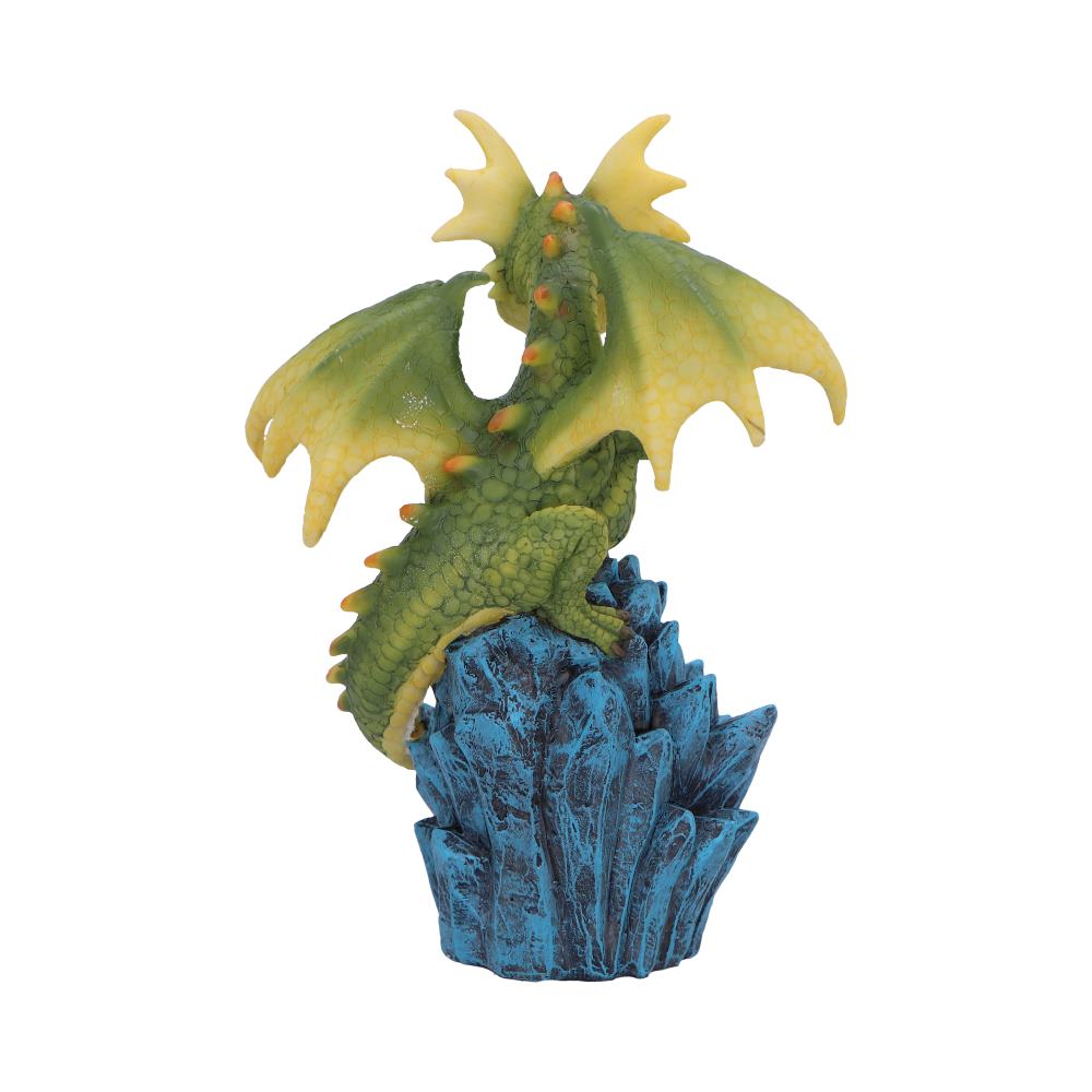 A green-yellow dragon figurine perches on a jagged blue rock formation, showcasing its textured scales and outspread wings. The background is plain white, highlighting the dragon's details.