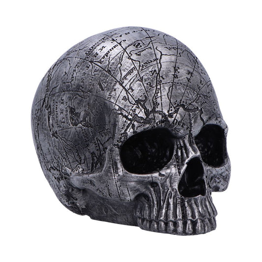 A silver skull displays intricate map-like engravings across its surface, placed against a plain white background, emphasizing its details and texture.