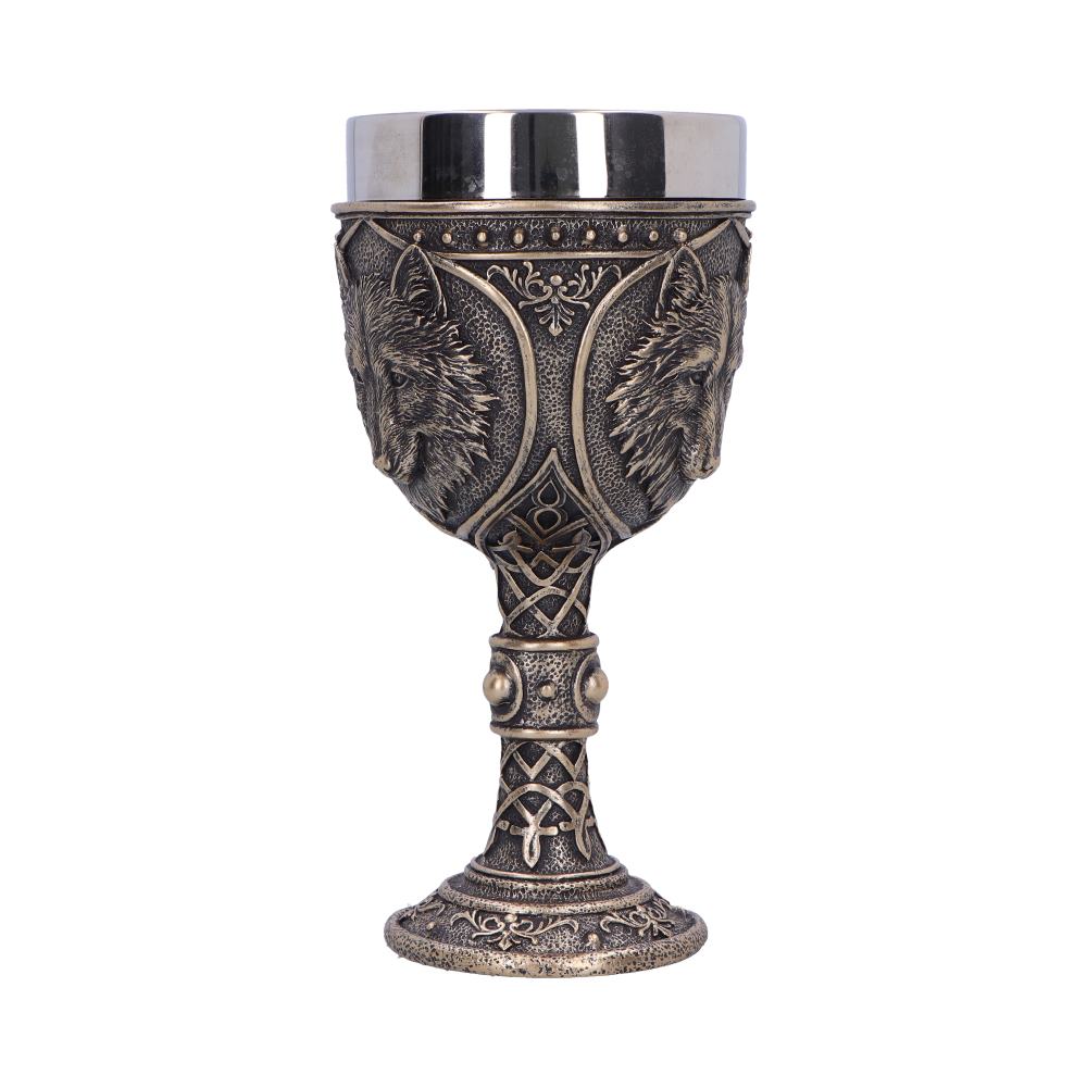 A goblet sits on a white background, its pewter-colored lip contrasting with the golden bronze wolf-head designs around the cup and ornate patterns on its base and stem.