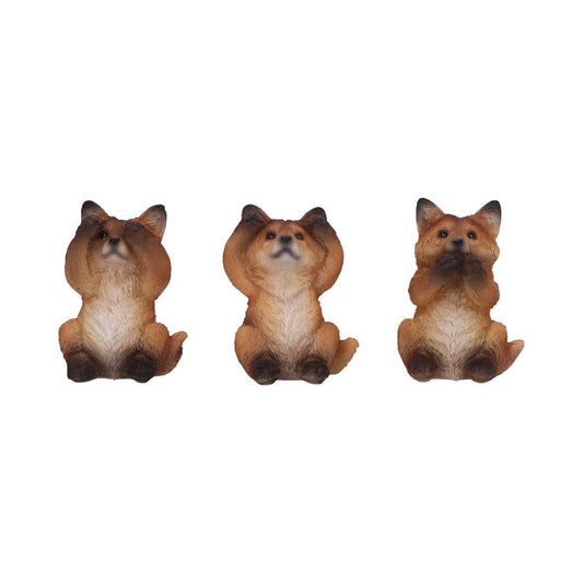 Three small fox figurines sit upright; one covers its eyes, another its ears, and the last its mouth, resembling the "see no evil, hear no evil, speak no evil" motif.