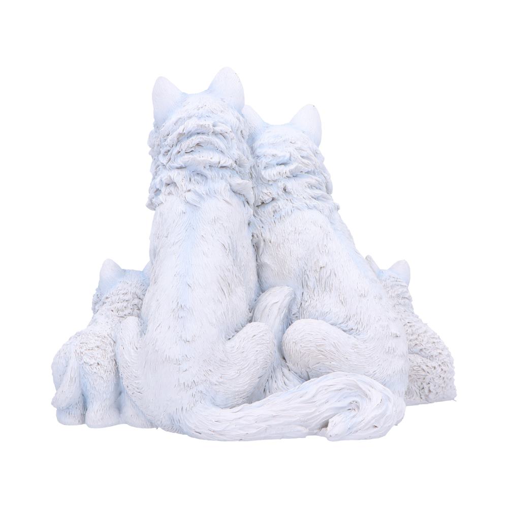 Two large white wolf sculptures sit closely, backs turned, with two smaller wolves nestled beside them, creating a family scene in a plain, white background.