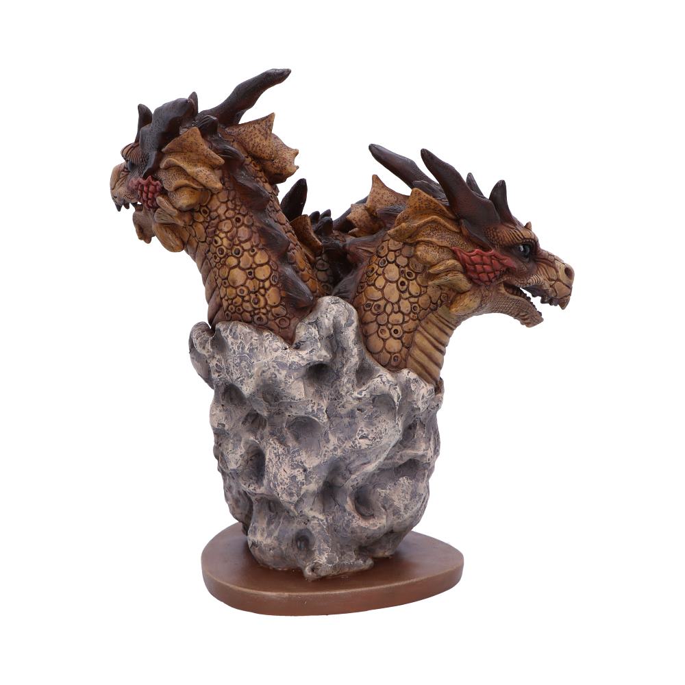 A sculpture depicts two dragon heads emerging from a textured, rocky base, with detailed scales and fierce expressions, set on a wooden platform.