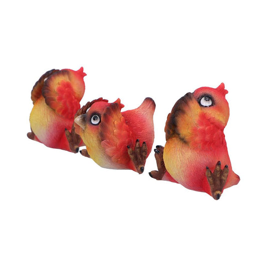 Three colorful ceramic birds with red, yellow, and brown hues are sitting in a line, facing different directions on a plain white background.