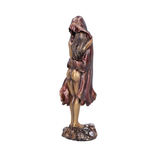 A bronze sculpture depicts a woman embracing a hooded figure, standing on a textured base. The figures are entwined, with the cloak draping over the woman's body.