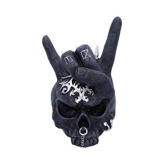 A dark skull adorned with metallic tribal ornaments and piercings rests in front of a hand displaying a rock-and-roll gesture, featuring a ring with Roman numeral II and spikes.