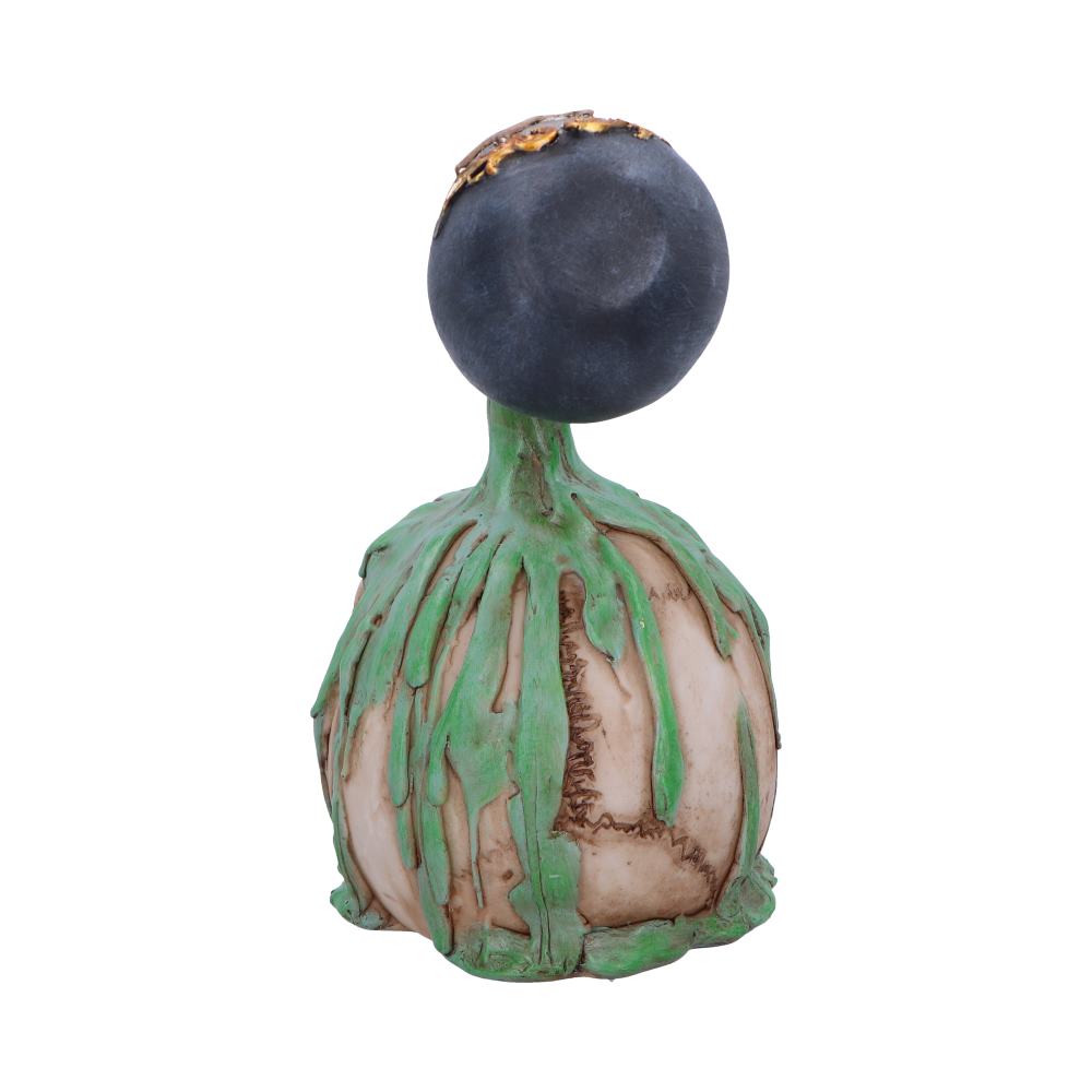 A ceramic sculpture features a large black sphere atop a textured base with green dripping accents, resembling an abstract plant or bulb, set against a plain white background.