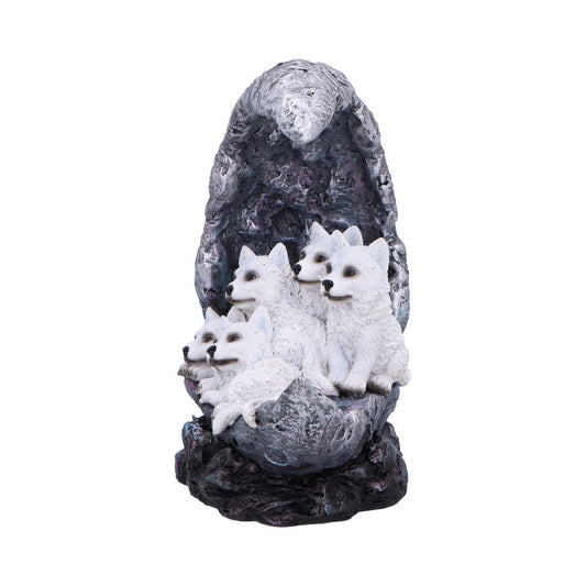 Five white wolf figures rest together, seated on a textured, rocky base with a tall, dark backdrop resembling a mountainous or cavernous setting. The wolves appear relaxed and huddled.
