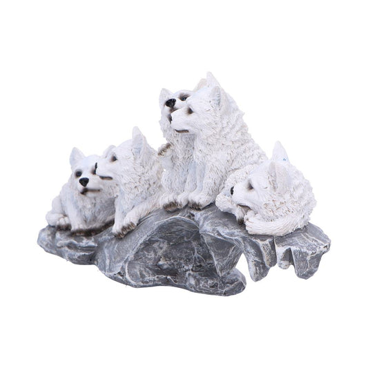 Five white wolf figurines are resting atop a rocky, textured surface, appearing serene in a natural setting reminiscent of a mountainous landscape.