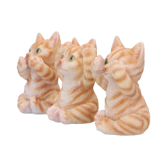 three orange tabby kitten figurines sit side by side, each raising front paws to their faces as if playing peekaboo on a plain white background