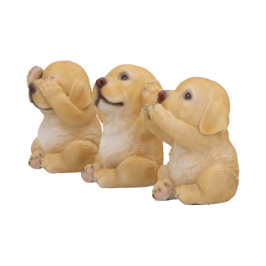 Three yellow labrador puppy figurines sit side by side; left covers its eyes, center covers its ears, right covers its mouth, all on a plain white background.
