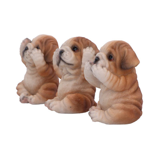 Three wrinkled brown bulldog puppy figurines sit side by side, one covering eyes, one covering ears, one covering mouth, isolated against a plain white background.