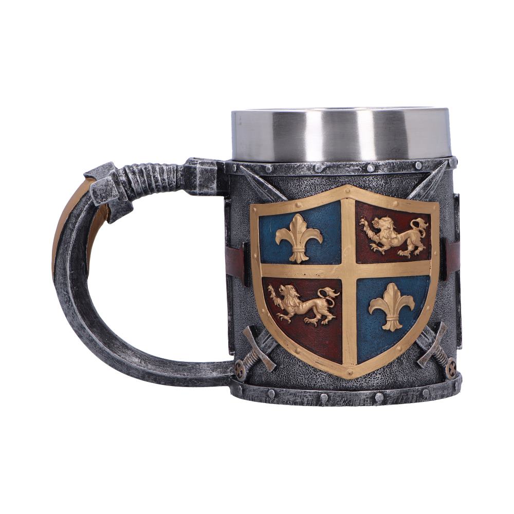 Pewter-style tankard sits centered, featuring a gold-framed heraldic shield with fleur-de-lis and lions, riveted medieval-style body and curved handle, isolated on a white background.