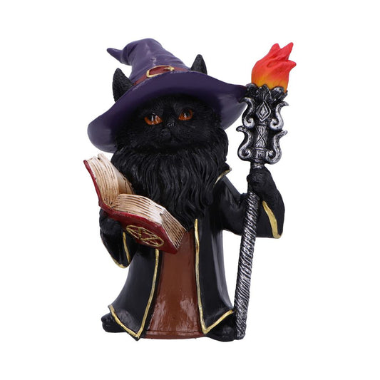 Black cat figurine wearing a purple wizard hat and black robe reads an open spellbook while holding an ornate staff topped with a red orange flame, photographed against a white background.