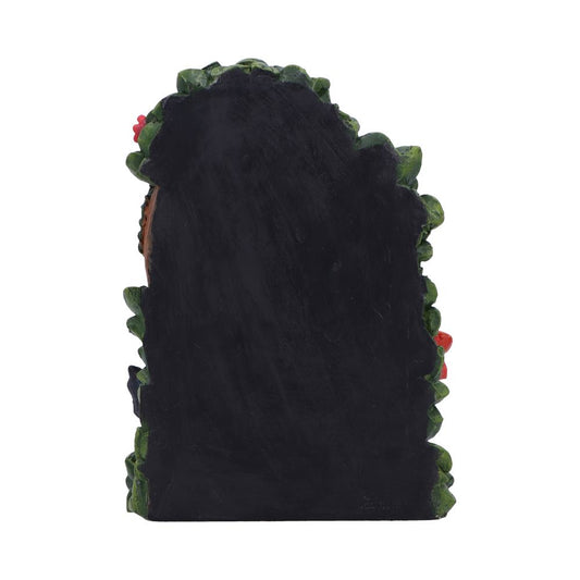 Decorative chalkboard plaque stands upright, bordered by sculpted green leaves and red berries, plain black writing surface centered against a clean white background.