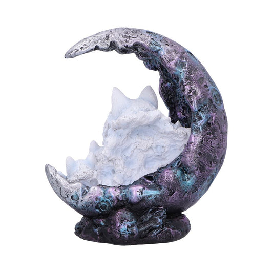 Crescent moon sculpture cradles a curled, sleeping white wolf figurine against a plain white background, the moon textured with iridescent purple and blue metallic tones.