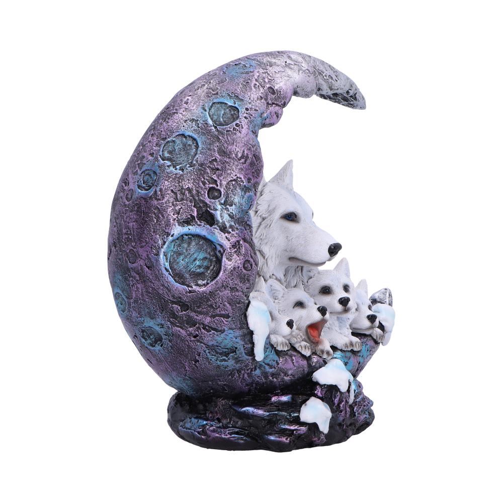 Purple cratered crescent moon sculpture cradles a white wolf and three pups peeking and nuzzling from its curve atop a rocky snowy base against a white background.