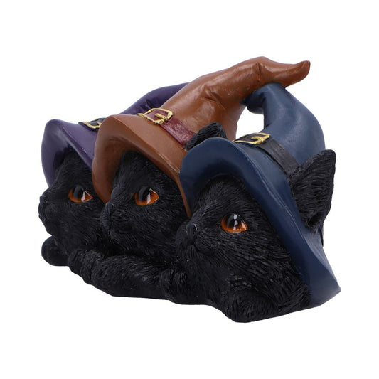 Three black cat figurines wear pointed witch hats, nestled side by side, gazing forward with amber eyes on a plain white background.