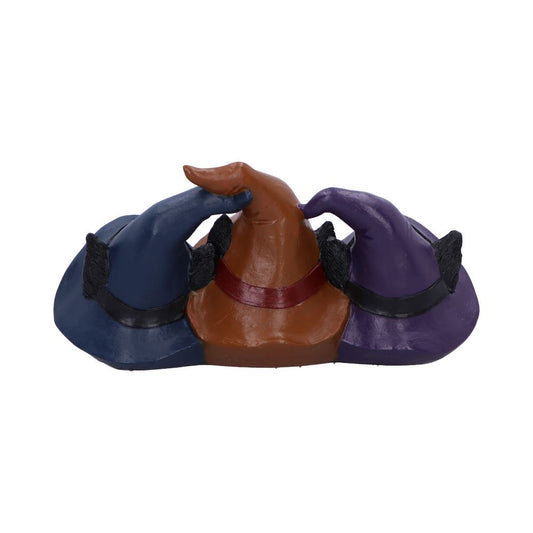 Three pointed witch hats sit touching side by side: navy blue (left), brown with red band (center), and purple (right), each with black cat-ear accents against a plain white background.