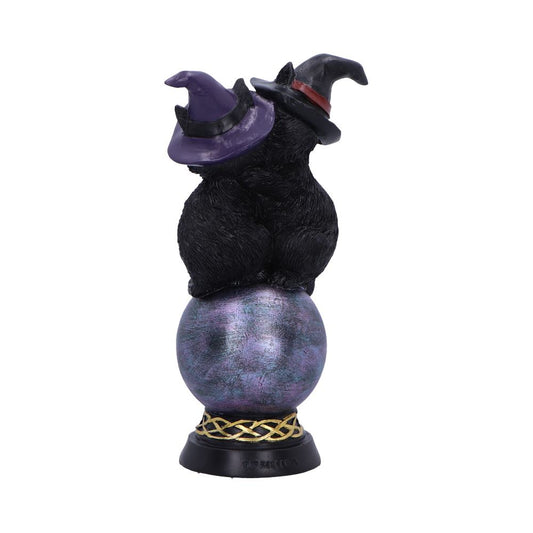 Two black cats wearing pointed witch hats sit back-to-back atop a metallic purple orb mounted on a decorative base against a plain white background.