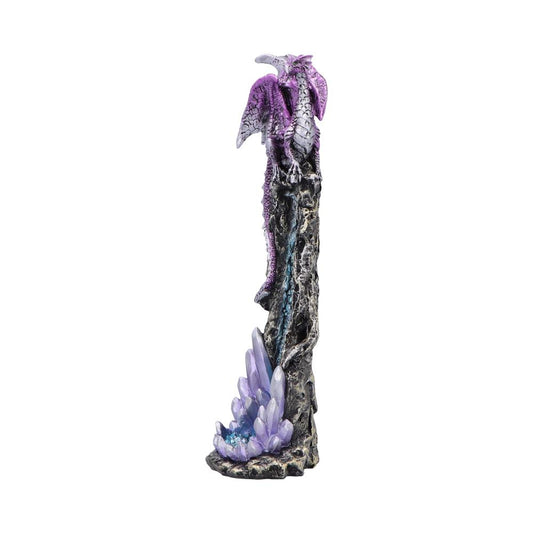 Purple dragon figurine perches atop a tall jagged rock spire, its wings folded around a column studded with lavender crystal clusters at the base on a white background.