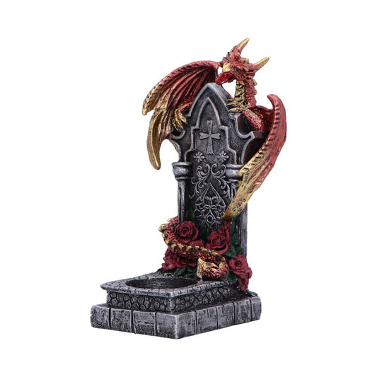 Red and gold dragon coils around a gothic stone tombstone, draping wings and a rose garland over a carved cross and floral motifs on a brick base.