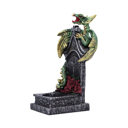 Green dragon statue coils around a weathered Gothic tombstone, roaring with open jaws while clutching the cross; red roses lie at the stone base in a stark white studio background.