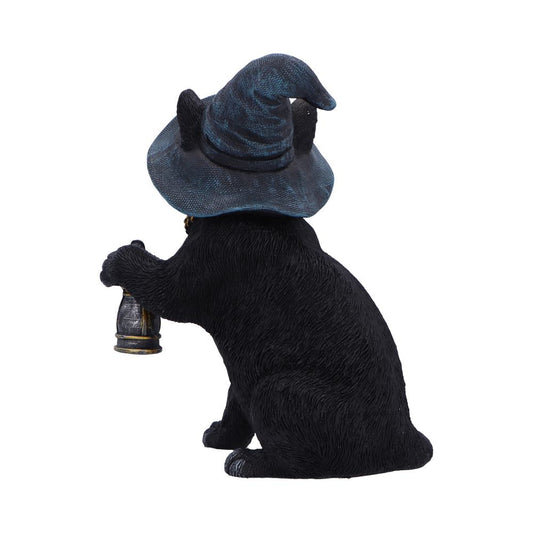 Black cat figurine sits facing away, wearing a wrinkled blue wizard hat and holding a small brass lantern in one paw against a plain white background.
