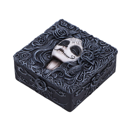 Square black decorative box with a sculpted white sugar-skull face nestled among swirling carved hair and roses, shown against a plain white background.