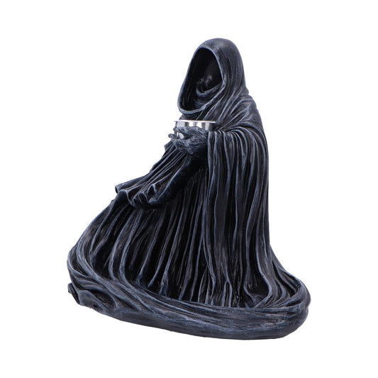 Hooded cloaked statue kneels and holds a small metal bowl in skeletal hands, heavy folded robes pooling around its base on a plain white background.