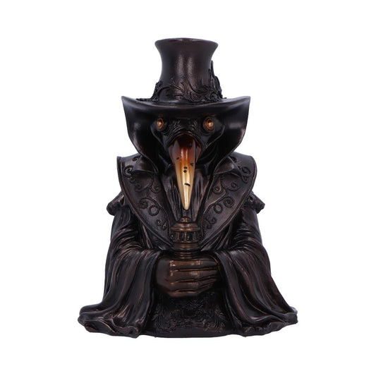 Bronze plague doctor statue stands with a tall hat and ornate cloak, beaked mask facing forward and hands clasping a candle holder, set against a plain white background.