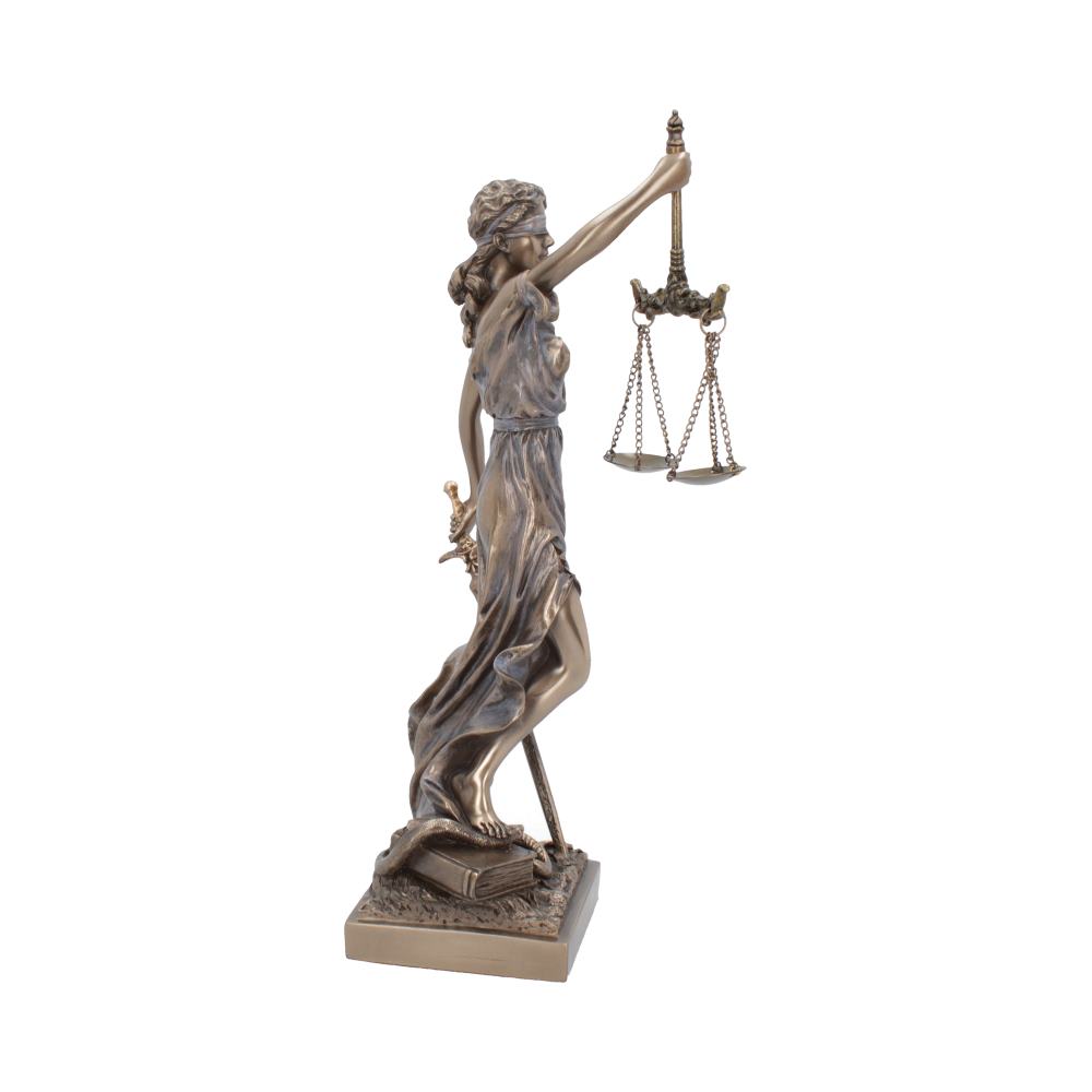 A bronze statue of Lady Justice, blindfolded, holding scales high in her right hand and a sword in her left, stands on a square base, against a plain backdrop.