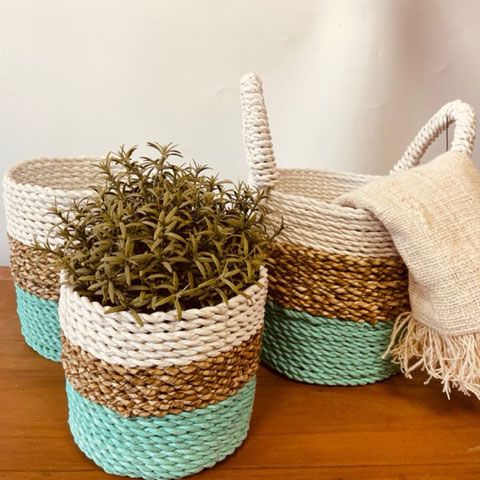 Set of woven handled baskets in natural finish for flexible home storage and interior styling