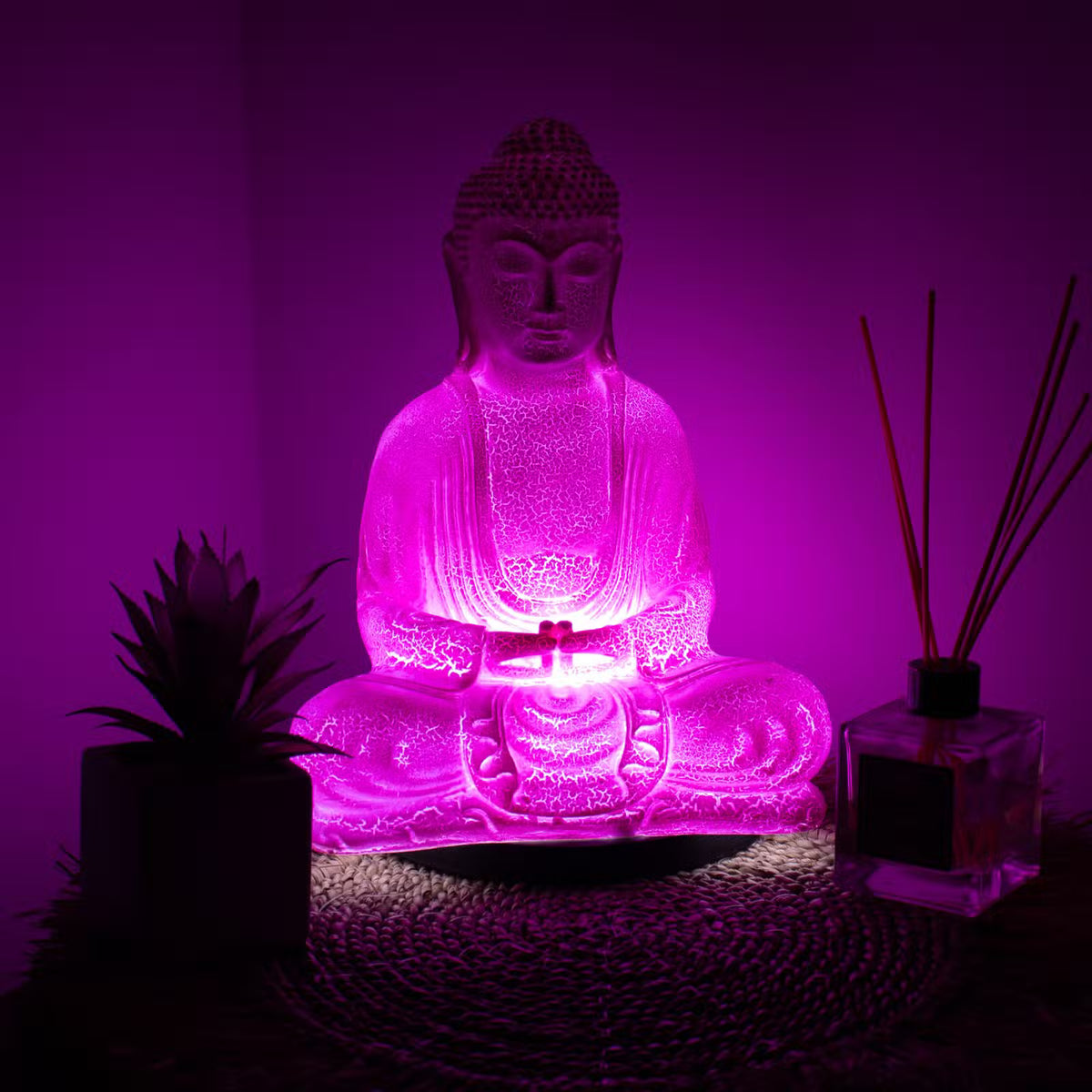 Cherry Crackle Meditation Buddha lamp with rich red-pink glow and black oval stand UK