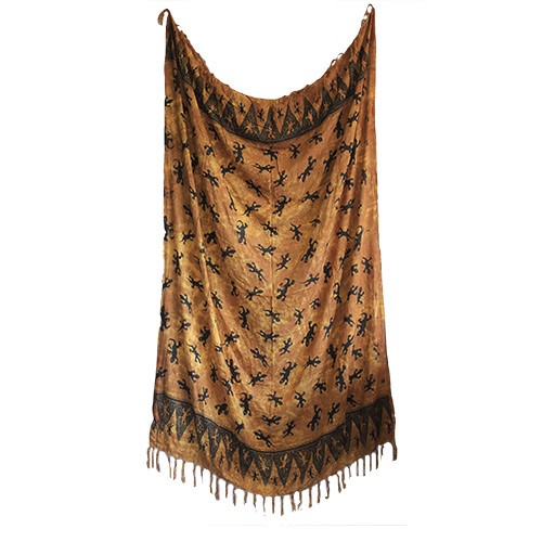 A large, rectangular textile hangs.  It's mustard-colored with a repeating pattern of dark brown lizards.  Fringes adorn the bottom.